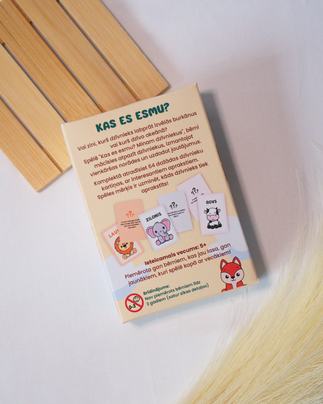 Educational card game with animal illustrations on a wooden surface