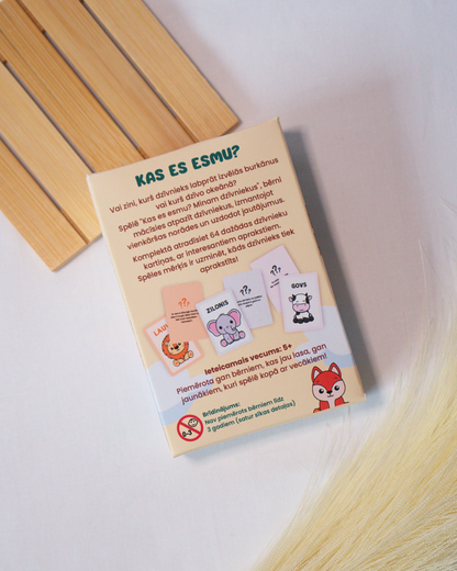 Educational card game with animal illustrations on a wooden surface